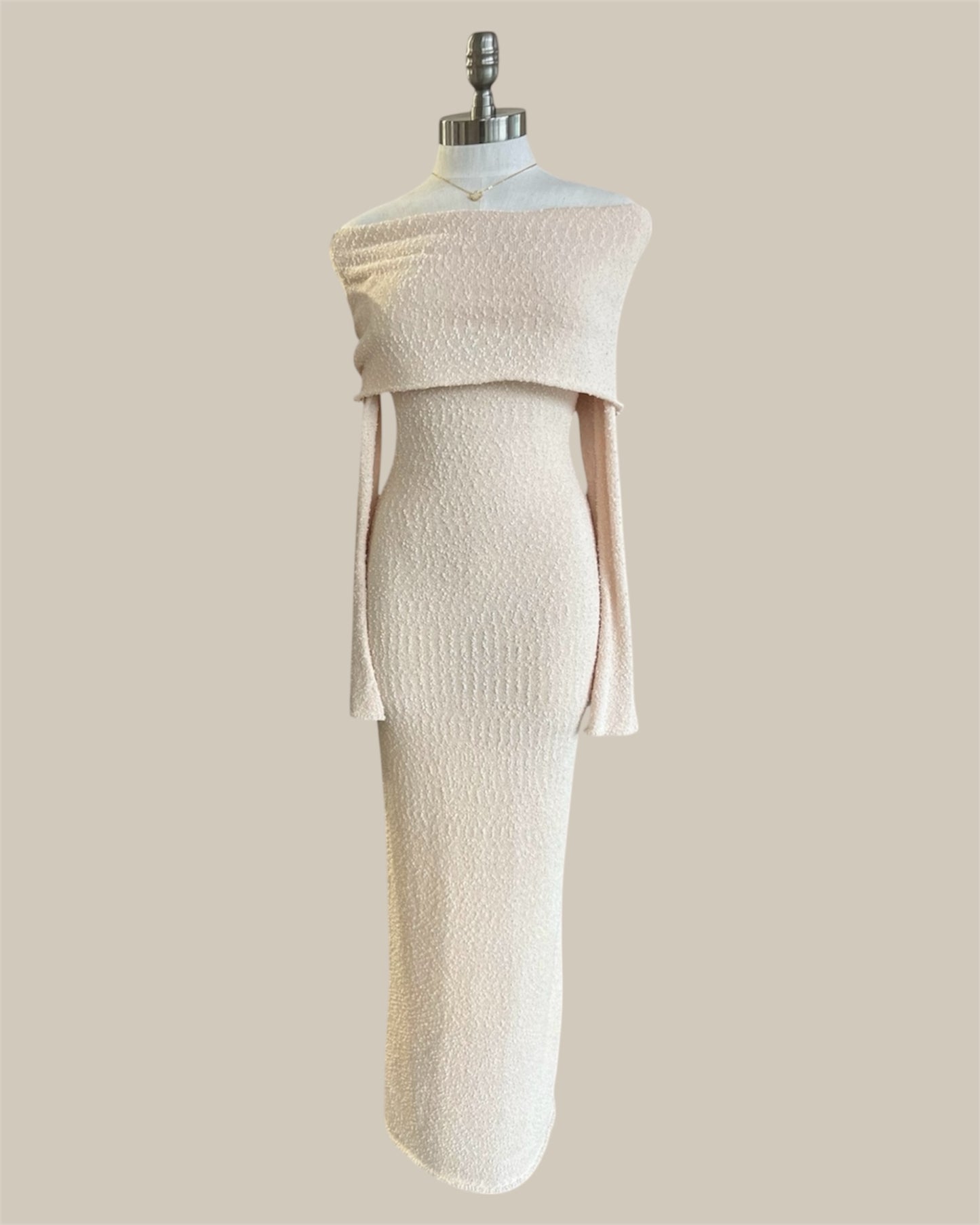 White dress on a mannequin against a beige background