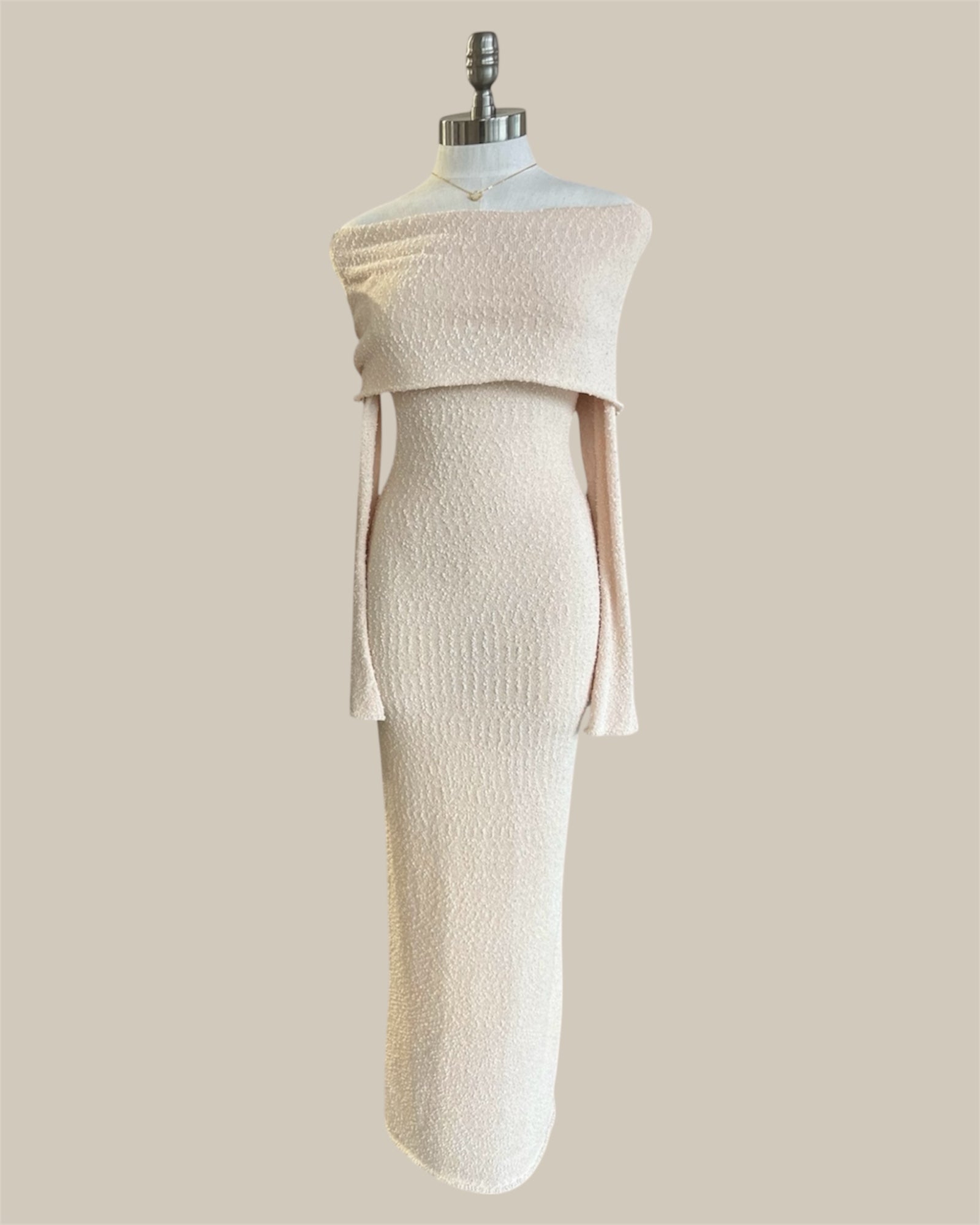 White dress on a mannequin against a beige background