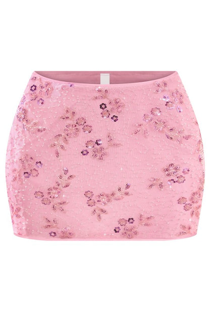Pink floral sequin skirt on a white background. This pink floral sequin mini skirt is the perfect party skirt for birthdays, date nights, vacations, and girls’ night outfits.