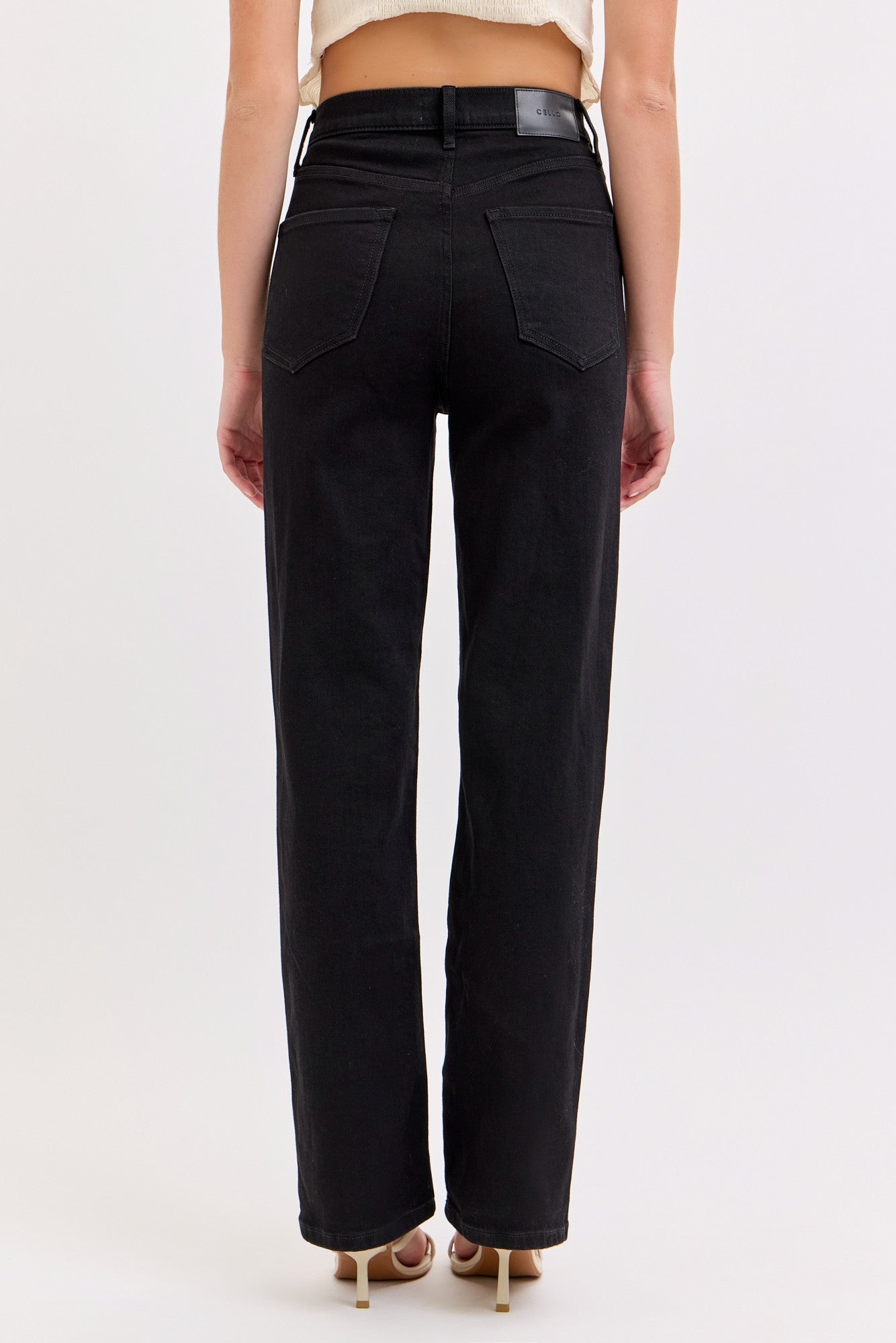 Back view of a woman wearing Cello High Rise Straight Leg Jeans in black, showing classic pocket design and straight leg fit.