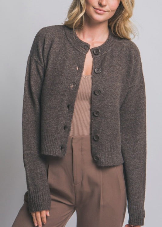  brown knitted cardigan over a beige top