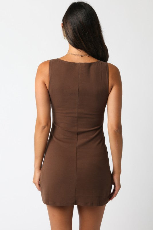 Model wearing sleeveless chocolate brown mini dress with high neckline Whittier Boutique